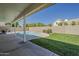 The home's covered patio overlooks a swimming pool and well-maintained landscaping in the backyard at 3802 W Sheffield Ave, Chandler, AZ 85226
