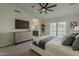 Serene bedroom featuring an ensuite bathroom, a ceiling fan, and outdoor access at 3802 W Sheffield Ave, Chandler, AZ 85226