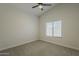 Well-lit bedroom with a ceiling fan, neutral carpet, and bright window at 3802 W Sheffield Ave, Chandler, AZ 85226