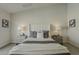 Bright bedroom featuring a ceiling fan, carpet, and nightstands with lamps on each side of the bed at 3802 W Sheffield Ave, Chandler, AZ 85226