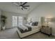 Comfortable bedroom featuring a ceiling fan, neutral color palette, and sliding glass doors to the outdoors at 3802 W Sheffield Ave, Chandler, AZ 85226