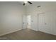 Bedroom featuring a ceiling fan, neutral carpet, and a closet with sliding doors at 3802 W Sheffield Ave, Chandler, AZ 85226