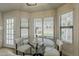 Bright breakfast nook features large windows, a glass table, and comfortable seating for enjoying morning meals at 3802 W Sheffield Ave, Chandler, AZ 85226
