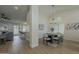 Open-concept dining room featuring modern chandelier, and seamless transition to living area at 3802 W Sheffield Ave, Chandler, AZ 85226