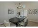 Bright dining room features modern chandelier, wood floors, and stylish decor, perfect for entertaining at 3802 W Sheffield Ave, Chandler, AZ 85226
