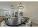 Open-concept dining area with chandelier, seamlessly connected to the living room, enhancing the home's appeal at 3802 W Sheffield Ave, Chandler, AZ 85226