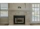 Elegant fireplace featuring stylish tile work, a modern mantel, and seamless access to outdoor views and natural light at 3802 W Sheffield Ave, Chandler, AZ 85226