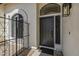 Inviting front entrance with a black door, decorative ironwork, and stylish outdoor lighting at 3802 W Sheffield Ave, Chandler, AZ 85226