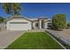 Charming single-story home with a well-manicured lawn, desert landscaping, and a two-car garage at 3802 W Sheffield Ave, Chandler, AZ 85226