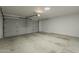 Empty two-car garage with a concrete floor and bright overhead lighting at 3802 W Sheffield Ave, Chandler, AZ 85226