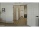 Hallway with a light wood floor between two rooms with white double doors at 3802 W Sheffield Ave, Chandler, AZ 85226