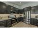 Well-equipped kitchen featuring stainless steel appliances, dark cabinetry, and modern countertops at 3802 W Sheffield Ave, Chandler, AZ 85226