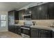 Bright kitchen with modern dark cabinets, stainless steel appliances, and ample counter space at 3802 W Sheffield Ave, Chandler, AZ 85226