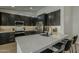 Stylish kitchen showcasing dark cabinets, stainless steel appliances, and a large countertop island at 3802 W Sheffield Ave, Chandler, AZ 85226