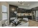 Open-concept kitchen with sleek dark cabinetry, stainless steel appliances, and modern lighting at 3802 W Sheffield Ave, Chandler, AZ 85226
