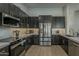 Modern kitchen equipped with stainless steel appliances, dark cabinets, and light countertops at 3802 W Sheffield Ave, Chandler, AZ 85226