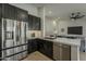 Kitchen area with stainless steel appliances, sleek cabinetry, and a view into the living space at 3802 W Sheffield Ave, Chandler, AZ 85226