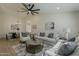 Open-concept living room with sofas, a round coffee table, and view of the dining area at 3802 W Sheffield Ave, Chandler, AZ 85226