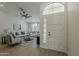 Bright living room featuring a white door, tile flooring, and a ceiling fan at 3802 W Sheffield Ave, Chandler, AZ 85226