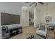 Open living space with large TV, accent chair, and view into the dining room at 3802 W Sheffield Ave, Chandler, AZ 85226