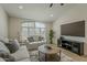 Comfortable living room with a large window, TV, stylish decor, and neutral color palette at 3802 W Sheffield Ave, Chandler, AZ 85226