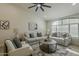 Cozy living room with two sofas, a round coffee table, neutral colors, and a large window at 3802 W Sheffield Ave, Chandler, AZ 85226