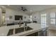 Open-concept living space showcasing a large island, fireplace, and comfortable seating area at 3802 W Sheffield Ave, Chandler, AZ 85226