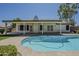 Backyard pool adjacent to covered patio, complemented by lush greenery, offers a serene outdoor oasis at 3802 W Sheffield Ave, Chandler, AZ 85226