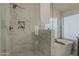 Elegant glass shower with marble details and a soaking tub at 3802 W Sheffield Ave, Chandler, AZ 85226
