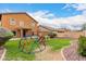Spacious backyard with green lawn and play area, ideal for Gathering fun and outdoor activities at 41227 W Granada Dr, Maricopa, AZ 85138