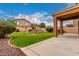 Spacious backyard with lush lawn, patio area, and recreational play equipment at 41227 W Granada Dr, Maricopa, AZ 85138