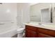 Well-lit bathroom featuring a vanity, toilet, and bathtub with shower at 41227 W Granada Dr, Maricopa, AZ 85138