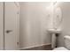 Half-bathroom with pedestal sink, updated lighting, and classic design at 41227 W Granada Dr, Maricopa, AZ 85138