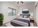 Beautifully staged bedroom featuring a stylish bed, soft lighting, and serene decor at 41227 W Granada Dr, Maricopa, AZ 85138