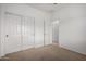 Neutral bedroom with white trim, carpeted floor, and closet at 41227 W Granada Dr, Maricopa, AZ 85138