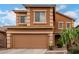 Inviting two-story home featuring a two-car garage and desert landscaping at 41227 W Granada Dr, Maricopa, AZ 85138