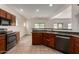 Well-appointed kitchen with stainless steel appliances, dark cabinets, and an open layout at 41227 W Granada Dr, Maricopa, AZ 85138