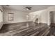 Large living room with elegant dark wood flooring and a staircase leading upstairs at 41227 W Granada Dr, Maricopa, AZ 85138