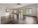 Spacious living room featuring wood flooring, sliding glass doors, and ample natural light at 41227 W Granada Dr, Maricopa, AZ 85138