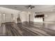 Open-concept living room featuring beautiful flooring, a staircase, and seamless flow at 41227 W Granada Dr, Maricopa, AZ 85138