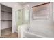 Elegant main bathroom featuring separate glass shower, soaking tub, and walk-in closet at 41227 W Granada Dr, Maricopa, AZ 85138