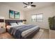Comfortable main bedroom with a ceiling fan, a large bed, and soft colors at 41227 W Granada Dr, Maricopa, AZ 85138