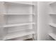 Walk-in pantry boasts ample shelving for optimal storage and organization at 41227 W Granada Dr, Maricopa, AZ 85138