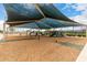 Community playground featuring swings, slides, and a shade structure for Gathering fun at 41227 W Granada Dr, Maricopa, AZ 85138
