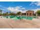 Community pool offers a serene setting with a stone structure and ample seating for relaxing by the water at 41227 W Granada Dr, Maricopa, AZ 85138