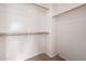 Spacious walk-in closet featuring ample shelving and rod space, ready for organization at 41227 W Granada Dr, Maricopa, AZ 85138