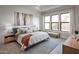 Inviting bedroom with a comfortable bed, accent pillows, and a large window with natural light at 42084 N Golden Trl, San Tan Valley, AZ 85140