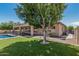 Inviting backyard featuring a pristine pool, well-manicured lawn, and ample space for outdoor enjoyment at 4718 E Decatur St, Mesa, AZ 85205