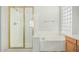 Clean bathroom features a walk-in shower and a soaking tub at 4718 E Decatur St, Mesa, AZ 85205