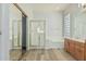 Bright bathroom with walk-in shower, bathtub, and wood cabinets at 4718 E Decatur St, Mesa, AZ 85205